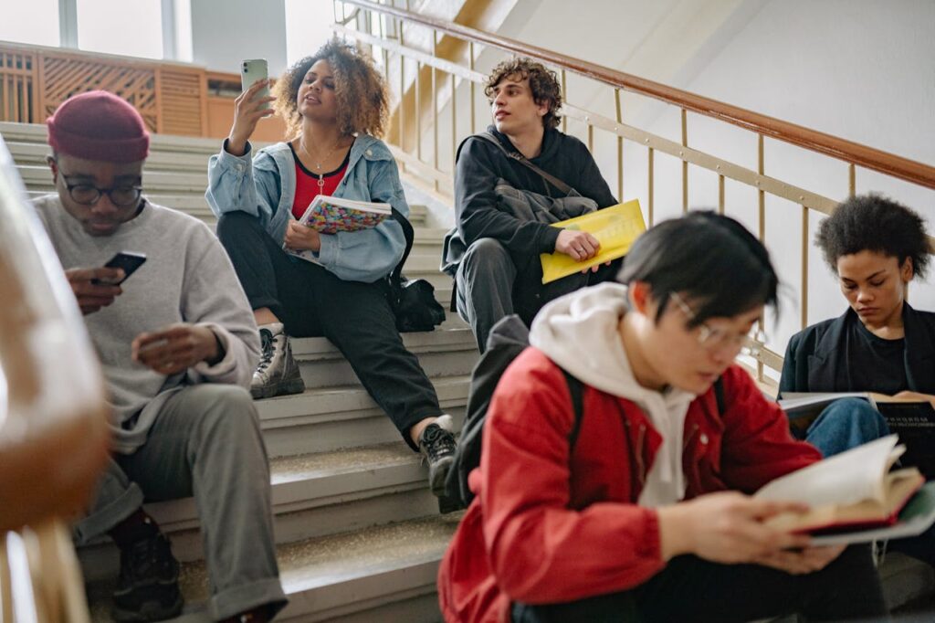 group of students sitting college campus after getting visa